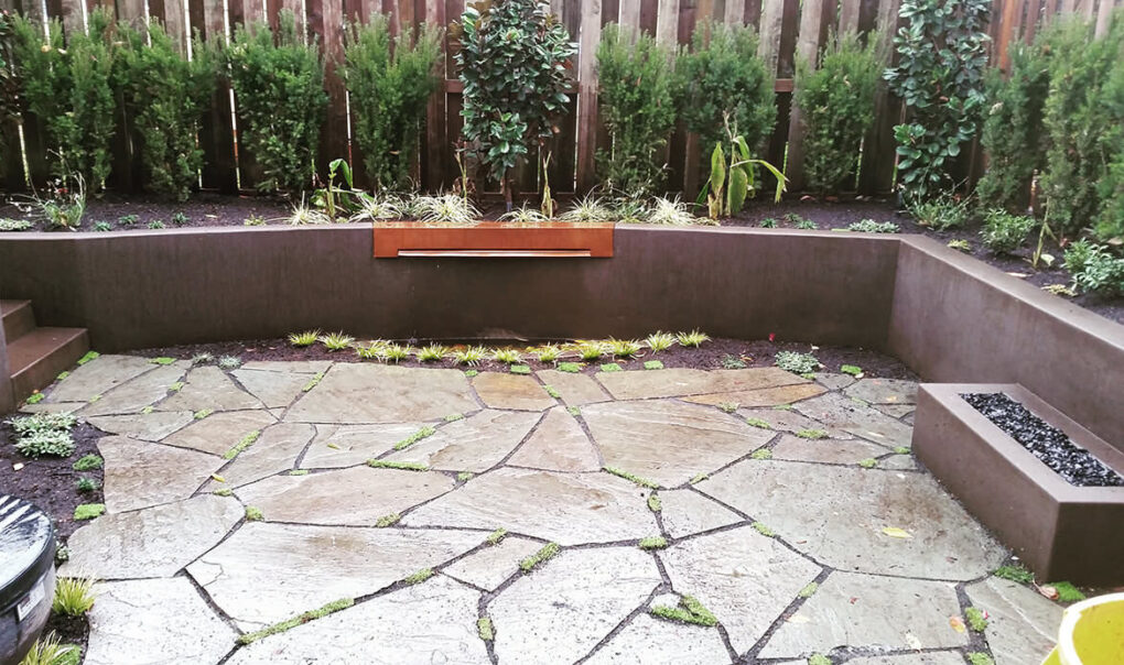 Backyard built in concrete seat wall firepit